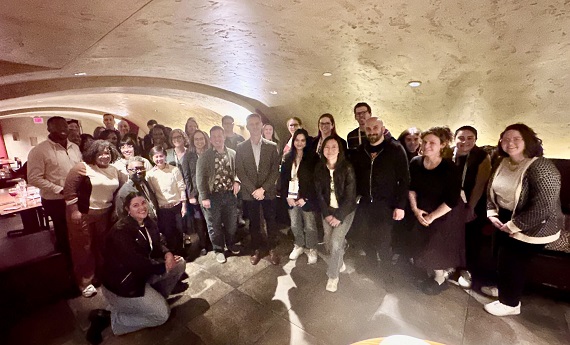 Alumni, faculty, staff and friends gather for a group shot at the Local bar